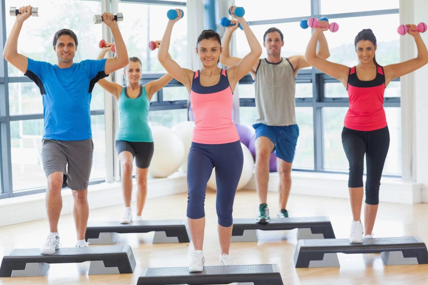 A group of people in gym doing exercises.