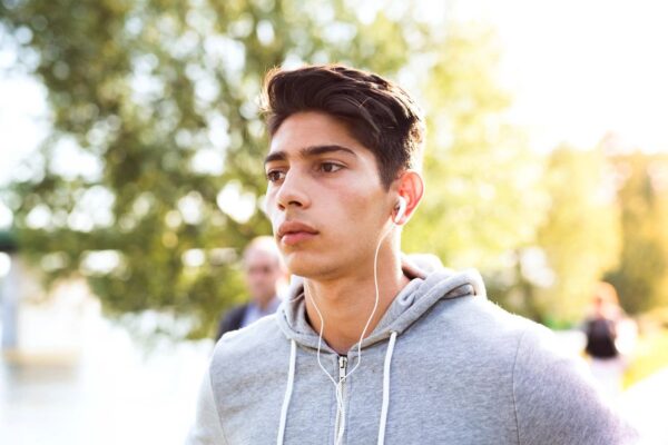 A man with headphones on looking at the camera.